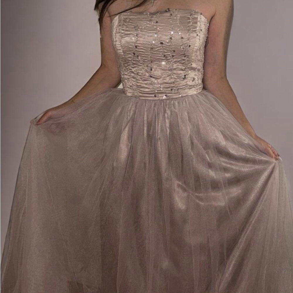 Long, flowing purple dress with sparkles, exuding princessy vibes and luxury.